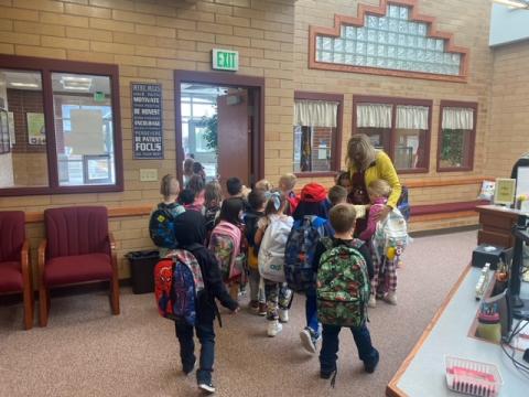 Kindergarten Students giving birthday hugs to the Principal