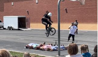BMX Riders Jumping Over Teachers